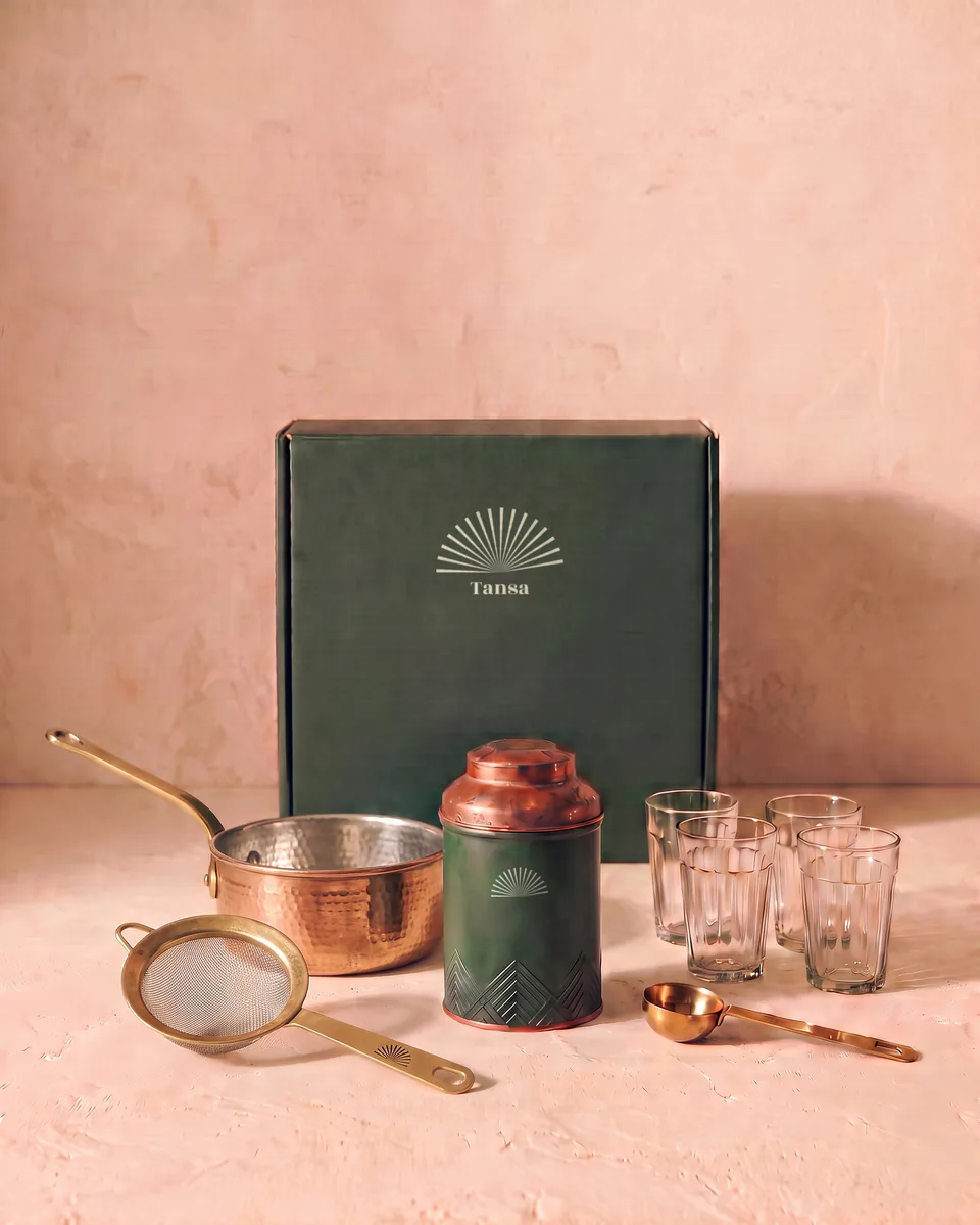 The whole chai kit: tin, copper pan, brass strainer, four glasses and brass measure, with its green gift box.